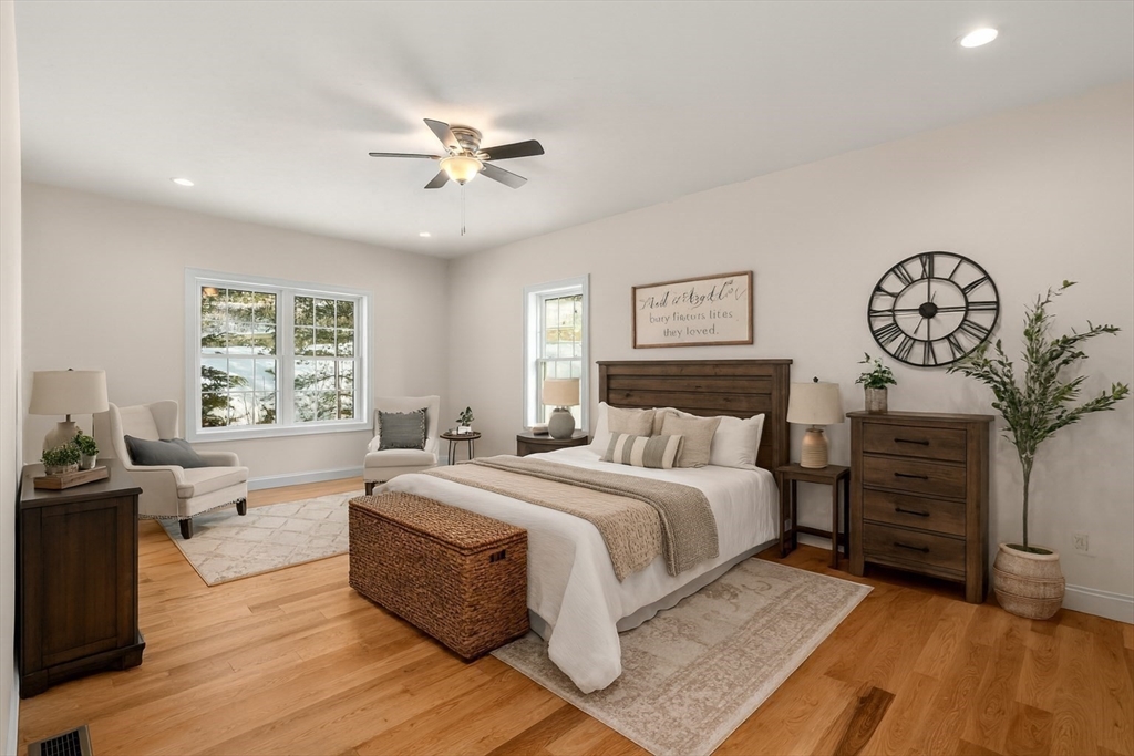 5 Miles Road Rutland, MA 01543 - Photo 18 of 37 a spacious bedroom with a large bed and a chandelier