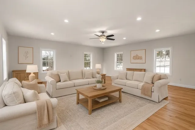 a living room with furniture and a wooden floor