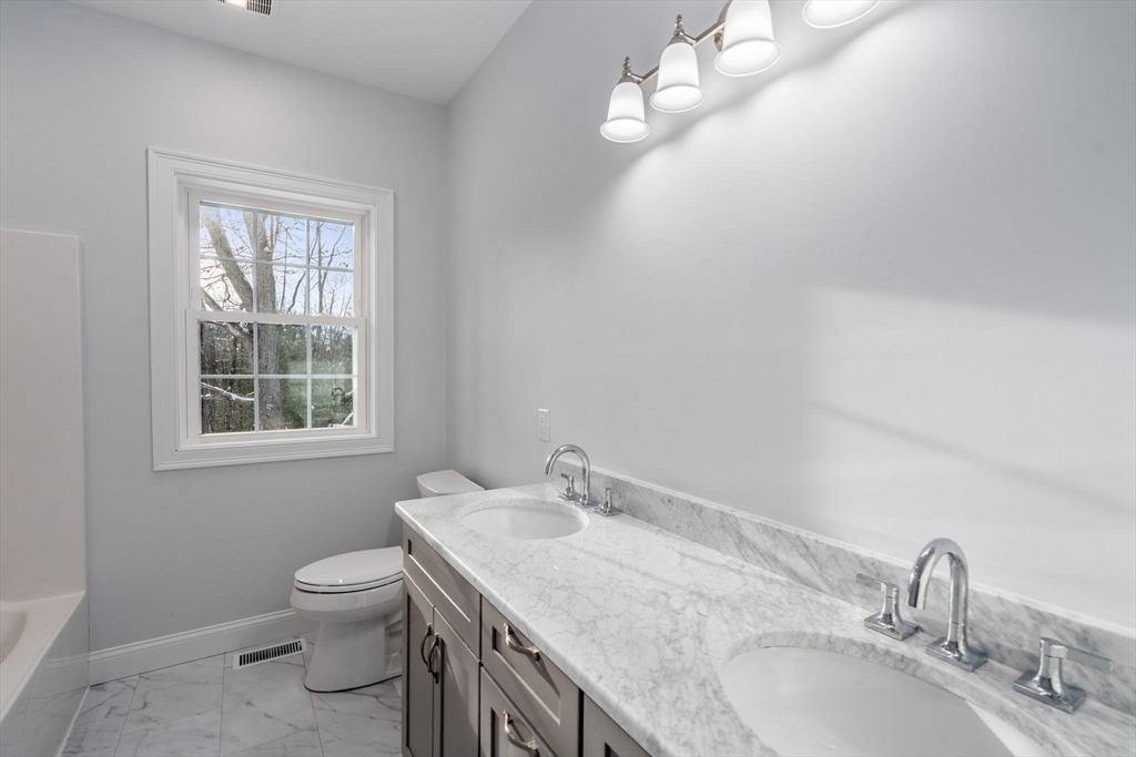 5 Miles Road Rutland, MA 01543 - Photo 21 of 37 a bathroom with a granite countertop sink a toilet and a window