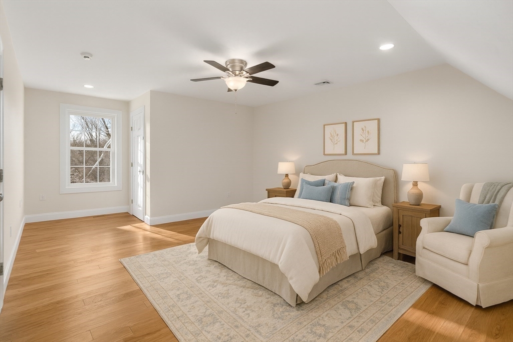 5 Miles Road Rutland, MA 01543 - Photo 25 of 37 a spacious bedroom with a large bed and a chandelier
