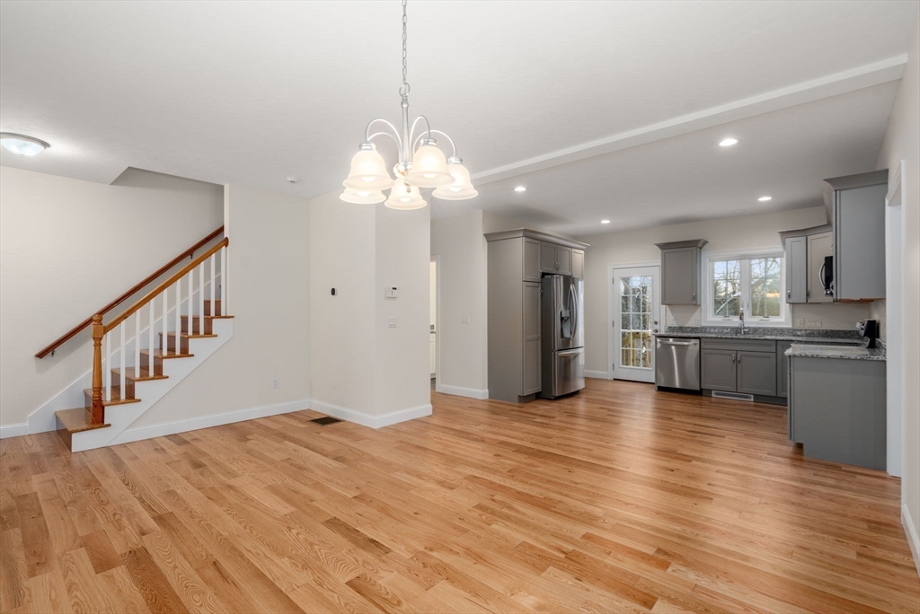 5 Miles Road Rutland, MA 01543 - Photo 9 of 35 a view of an empty room and kitchen with wooden floor