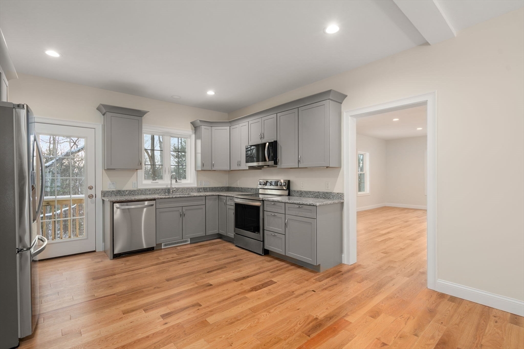 5 Miles Road Rutland, MA 01543 - Photo 10 of 35 a kitchen with granite countertop a stove top oven sink and cabinets