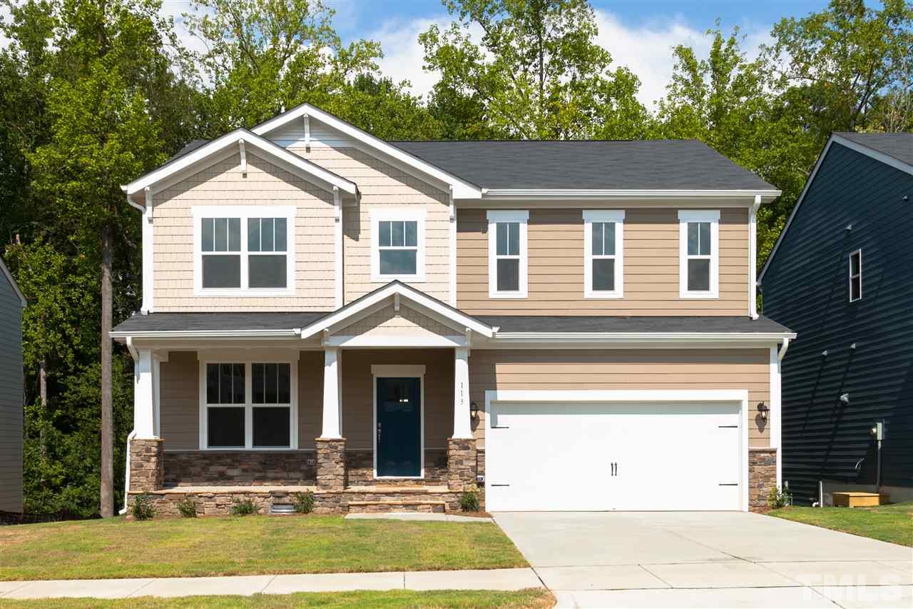 113 Spring Pine Lane Holly Springs, NC 27540 - Photo 1 of 25 a front view of a house with yard
