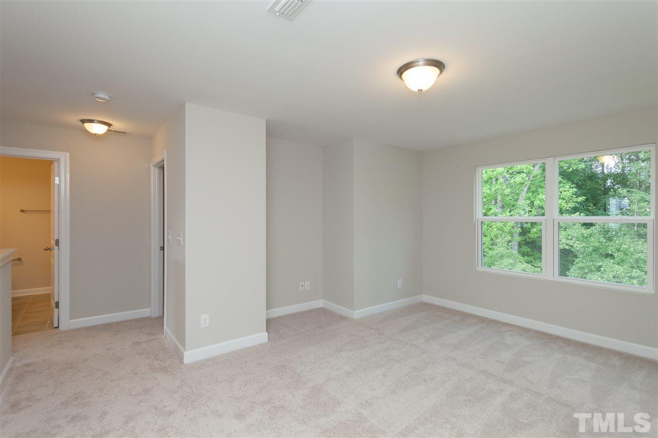 113 Spring Pine Lane Holly Springs, NC 27540 - Photo 16 of 25 a view of an empty room with a window