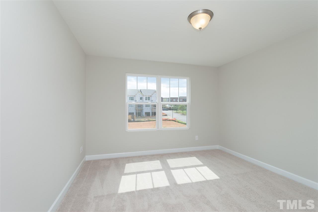 113 Spring Pine Lane Holly Springs, NC 27540 - Photo 19 of 25 an empty room with a window