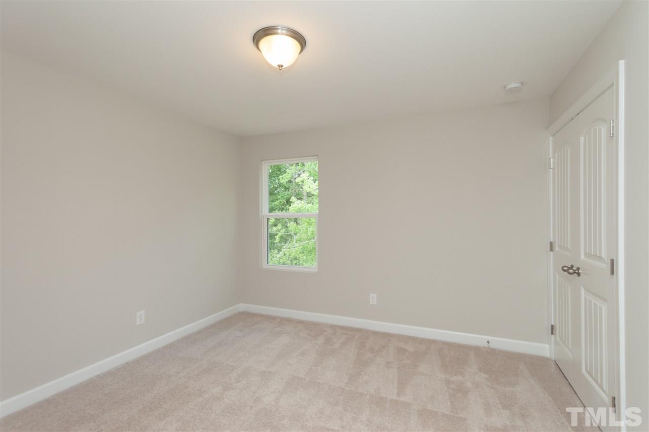 113 Spring Pine Lane Holly Springs, NC 27540 - Photo 21 of 25 an empty room with windows