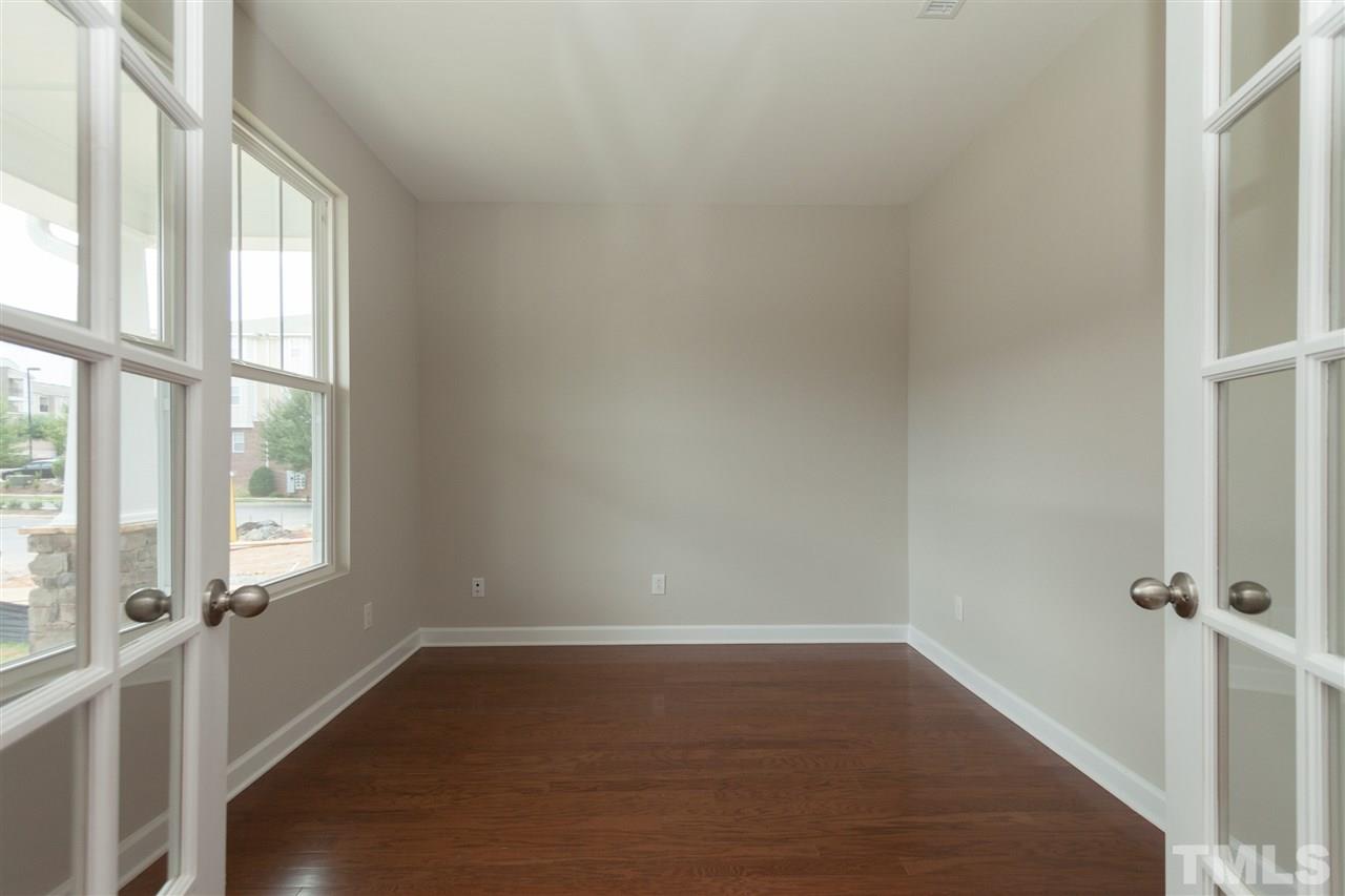 113 Spring Pine Lane Holly Springs, NC 27540 - Photo 3 of 25 a view of an empty room with a window