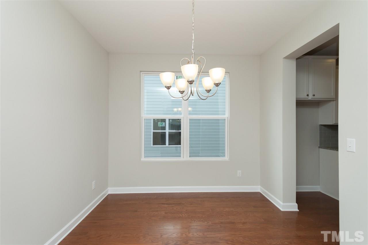 113 Spring Pine Lane Holly Springs, NC 27540 - Photo 4 of 25 a view of an empty room with a window