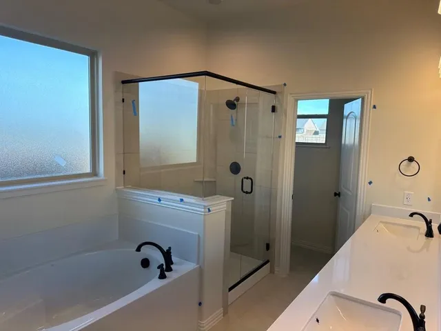 a bathroom with a tub and shower