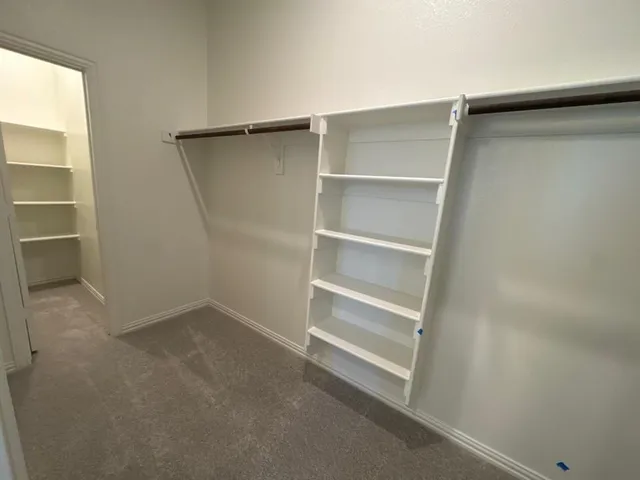 a view of an empty walk in closet