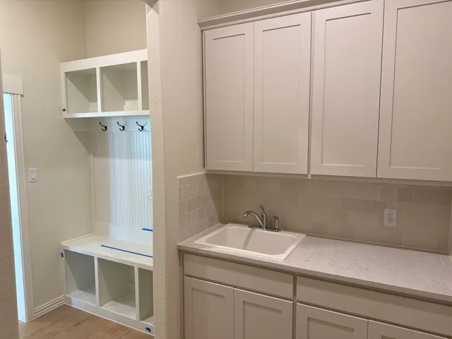 a bathroom with a sink and cabinets
