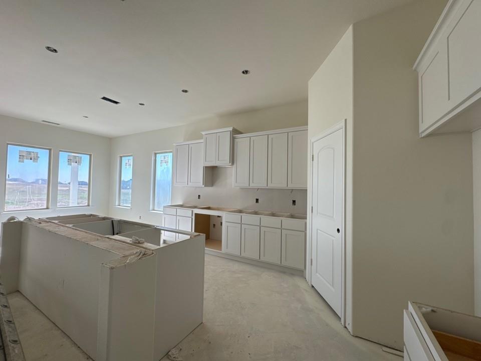 114 Brandywine Trail Rhome, TX 76078 - Photo 8 of 17 a kitchen with stainless steel appliances granite countertop a sink and a stove with white countertops