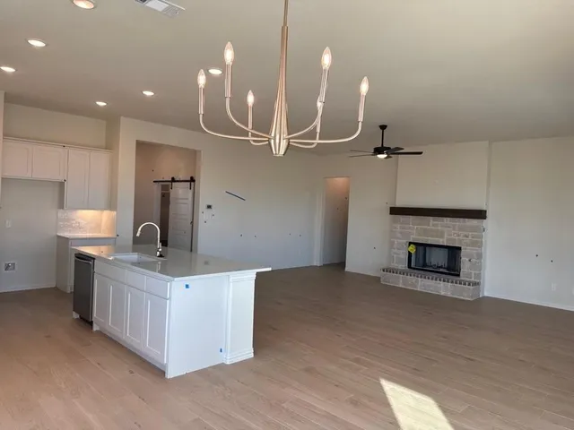 a kitchen with a sink and a fireplace