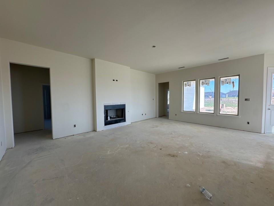 114 Brandywine Trail Rhome, TX 76078 - Photo 9 of 17 a view of an empty room with a window and fireplace