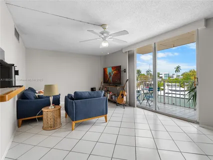 a living room with furniture and a floor to ceiling window