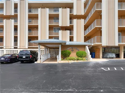 a view of building with car parked
