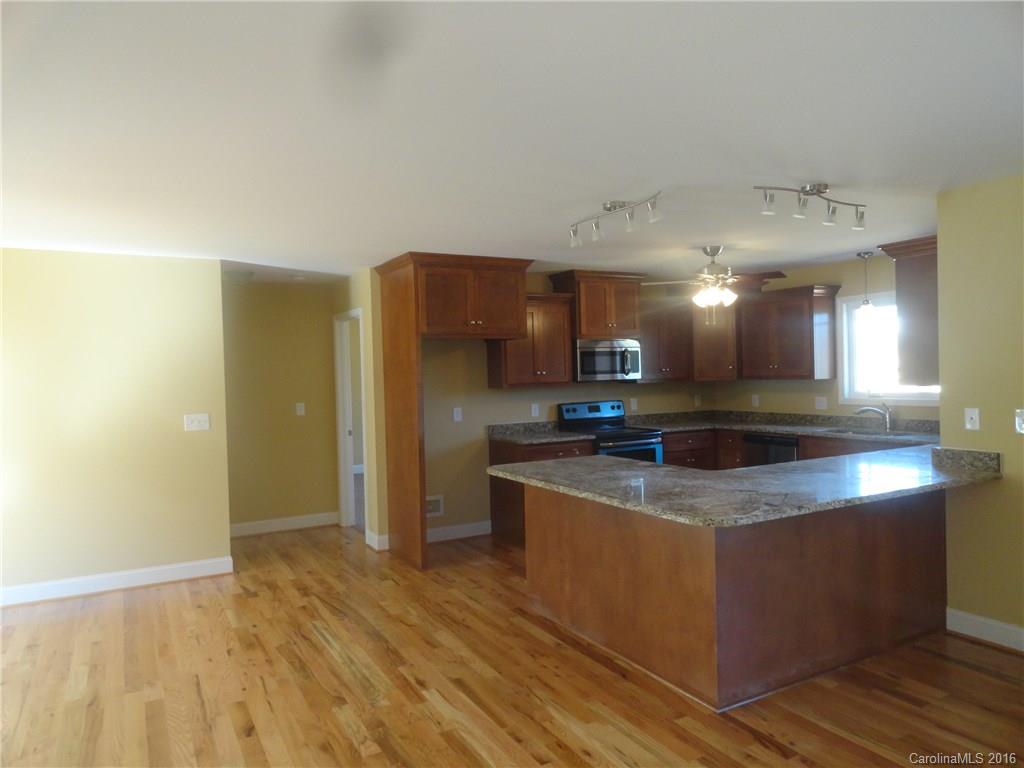4767 Kemp Dellinger Road, Unit 2 Maiden, NC 28650 - Photo 11 of 21 a kitchen with stainless steel appliances granite countertop a sink a stove a refrigerator and a oven