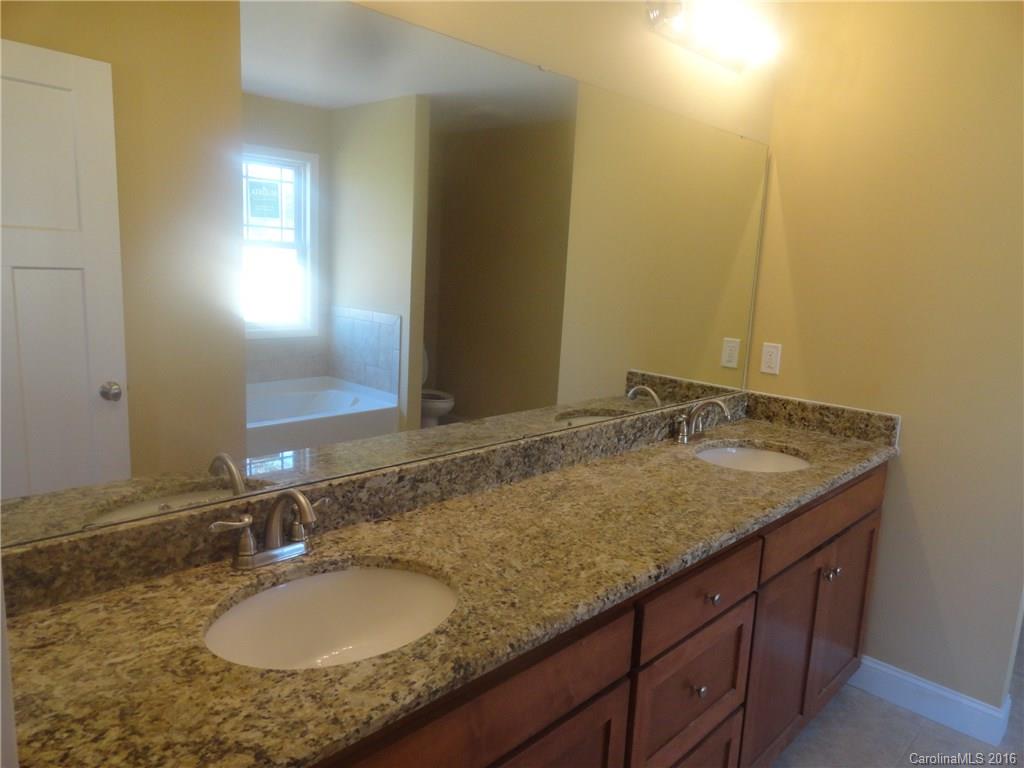 4767 Kemp Dellinger Road, Unit 2 Maiden, NC 28650 - Photo 15 of 21 a bathroom with a granite countertop sink and a mirror