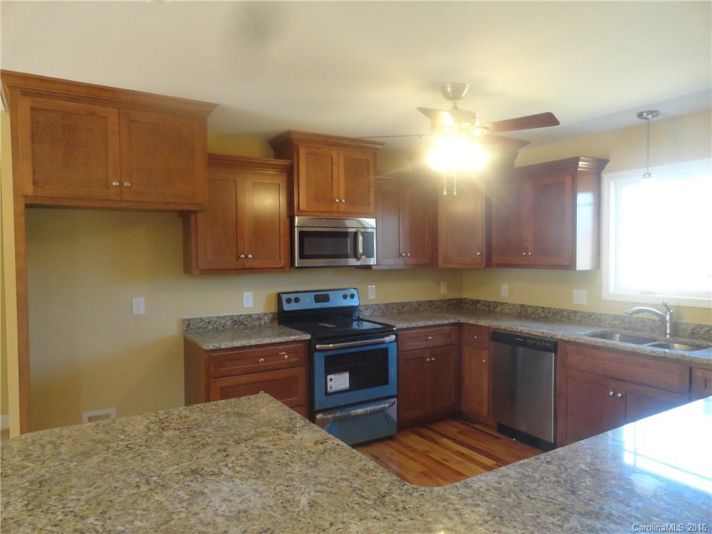 4767 Kemp Dellinger Road, Unit 2 Maiden, NC 28650 - Photo 7 of 21 a kitchen with stainless steel appliances granite countertop a sink stove and cabinets