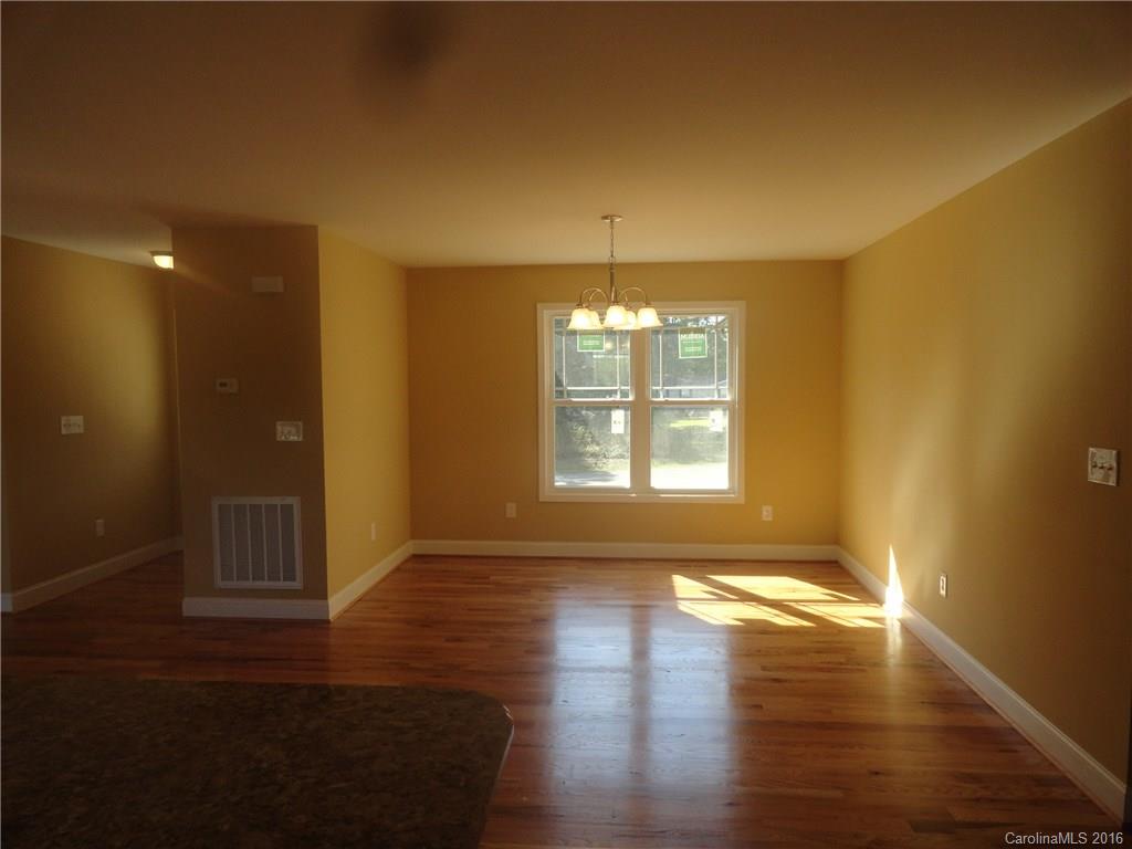 4767 Kemp Dellinger Road, Unit 2 Maiden, NC 28650 - Photo 10 of 21 a view of an empty room with wooden floor and a window