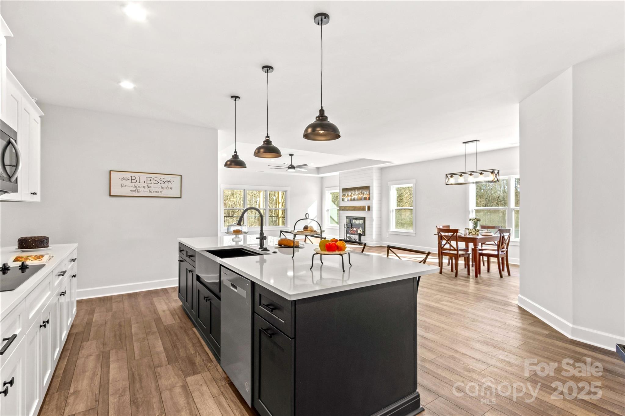 1215 Coppergate Drive Salisbury, NC 28147 - Photo 18 of 41 a kitchen with a counter top space a sink a stove and wooden floor
