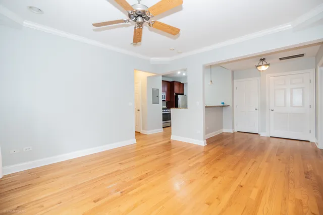 a view of empty room with wooden floor and window