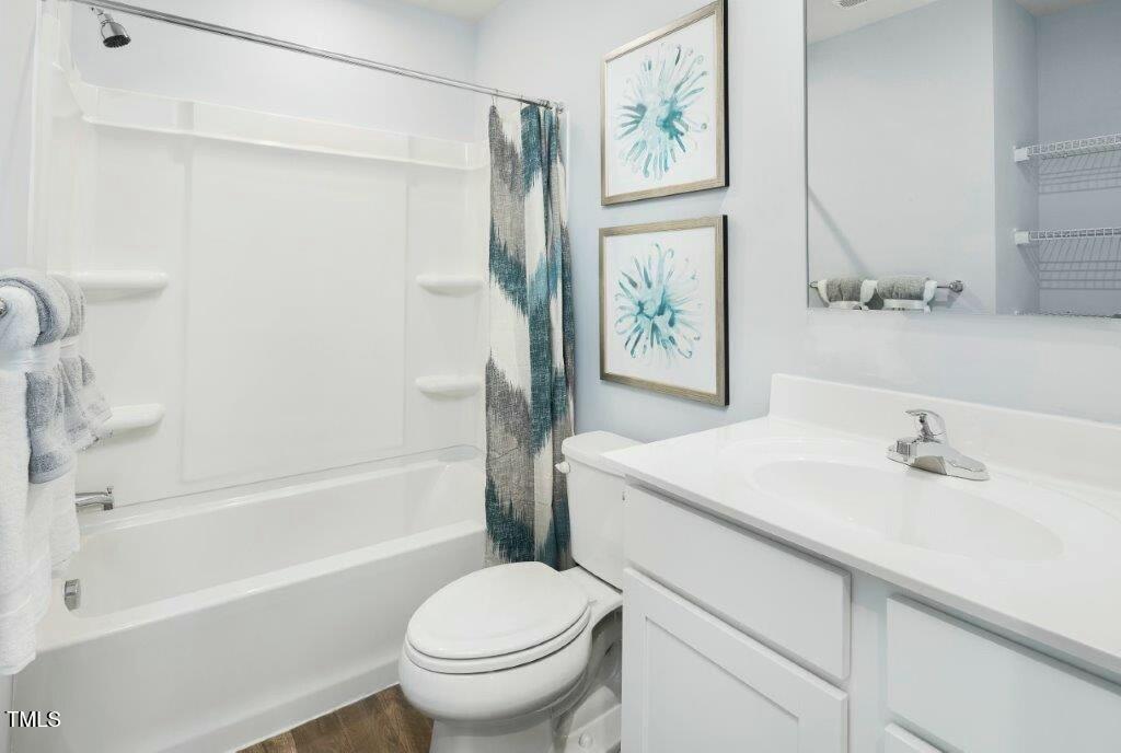 153 Sunny Acrs Road Raleigh, NC 27603 - Photo 13 of 17 a bathroom with a sink toilet and shower
