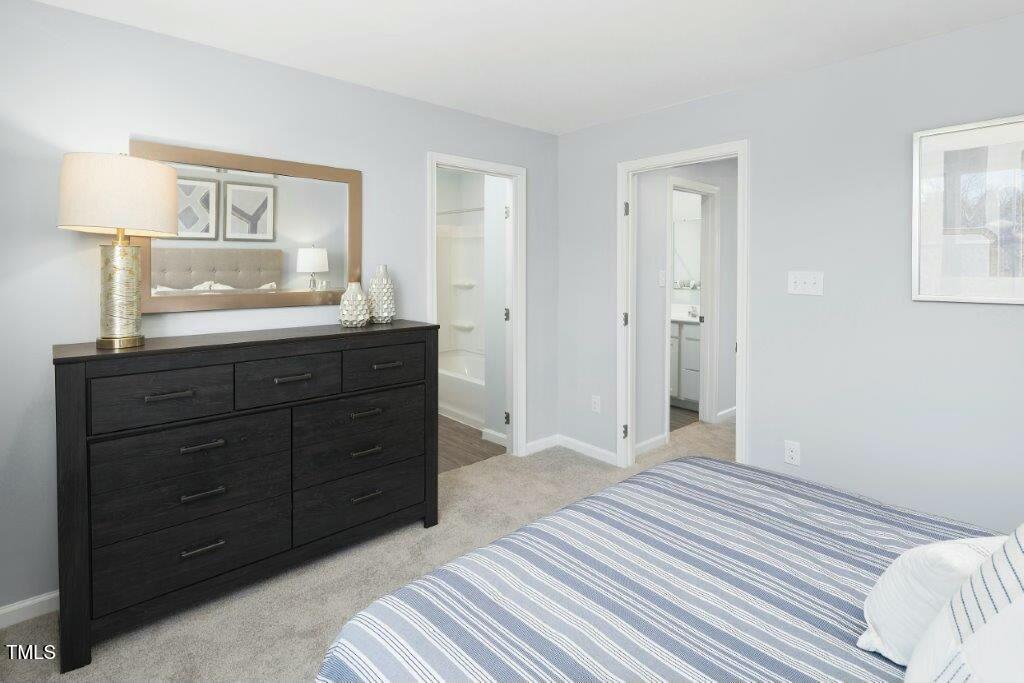 153 Sunny Acrs Road Raleigh, NC 27603 - Photo 8 of 17 a bedroom with a bed and a mirror on dresser