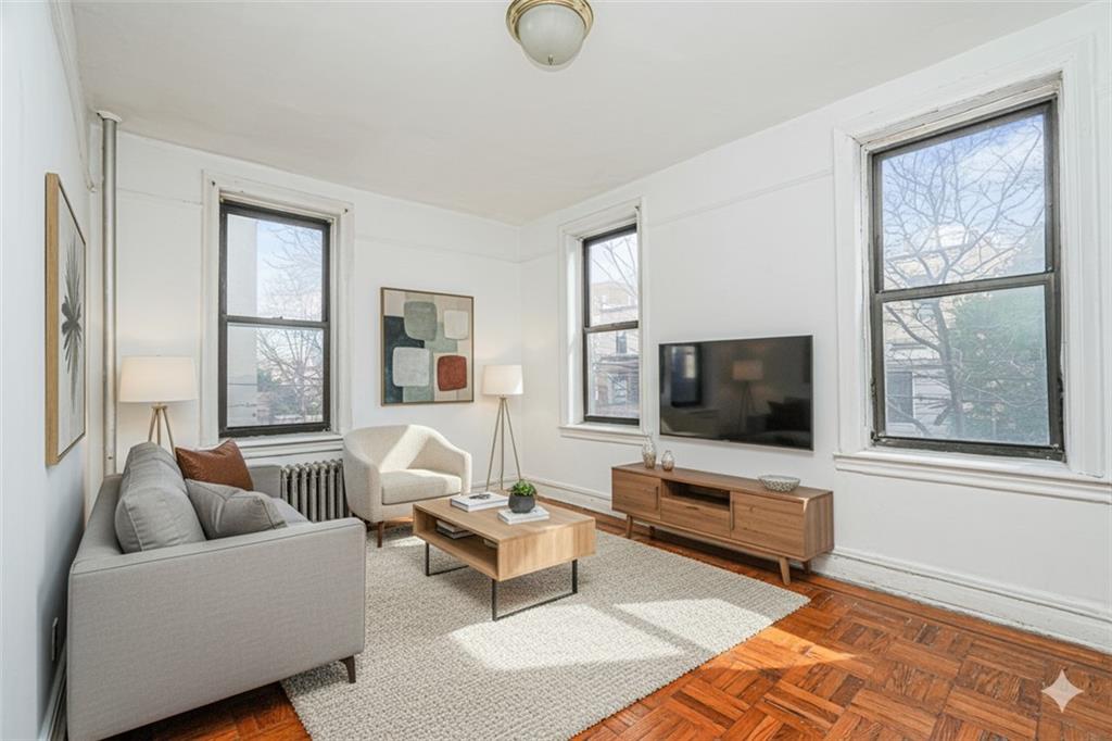 255 79th Street, Unit B2 Brooklyn, NY 11209 - Photo 1 of 22 a living room with furniture and a flat screen tv