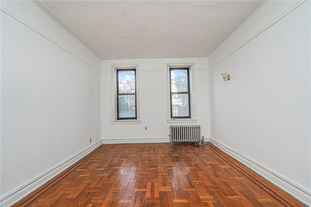 255 79th Street, Unit B2 Brooklyn, NY 11209 - Photo 11 of 22 wooden floor in an empty room with a window