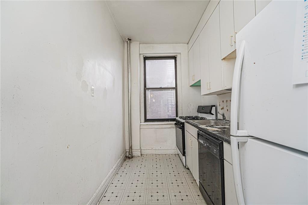 255 79th Street, Unit B2 Brooklyn, NY 11209 - Photo 17 of 22 a kitchen with a stove a sink and a refrigerator