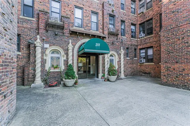 front view of a brick building with many windows