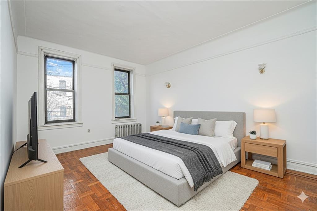 255 79th Street, Unit B2 Brooklyn, NY 11209 - Photo 6 of 22 a bedroom with a bed and a couch
