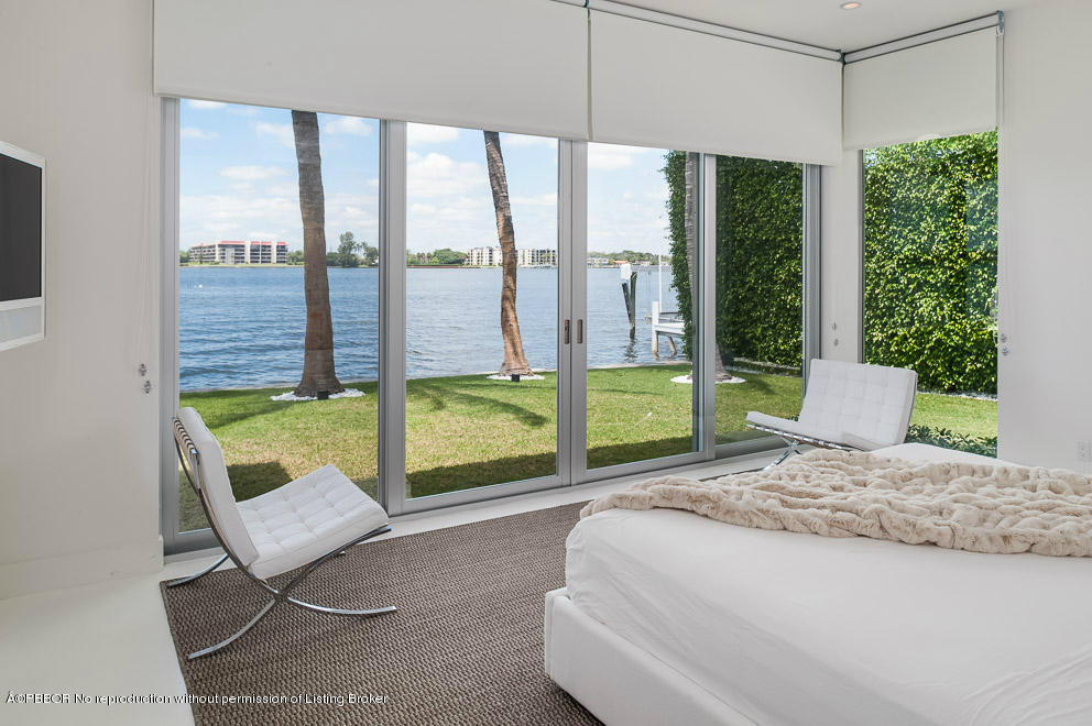 1225 Lands End Road Manalapan, FL 33462 - Photo 11 of 28 a bed sitting in a bedroom next to a window
