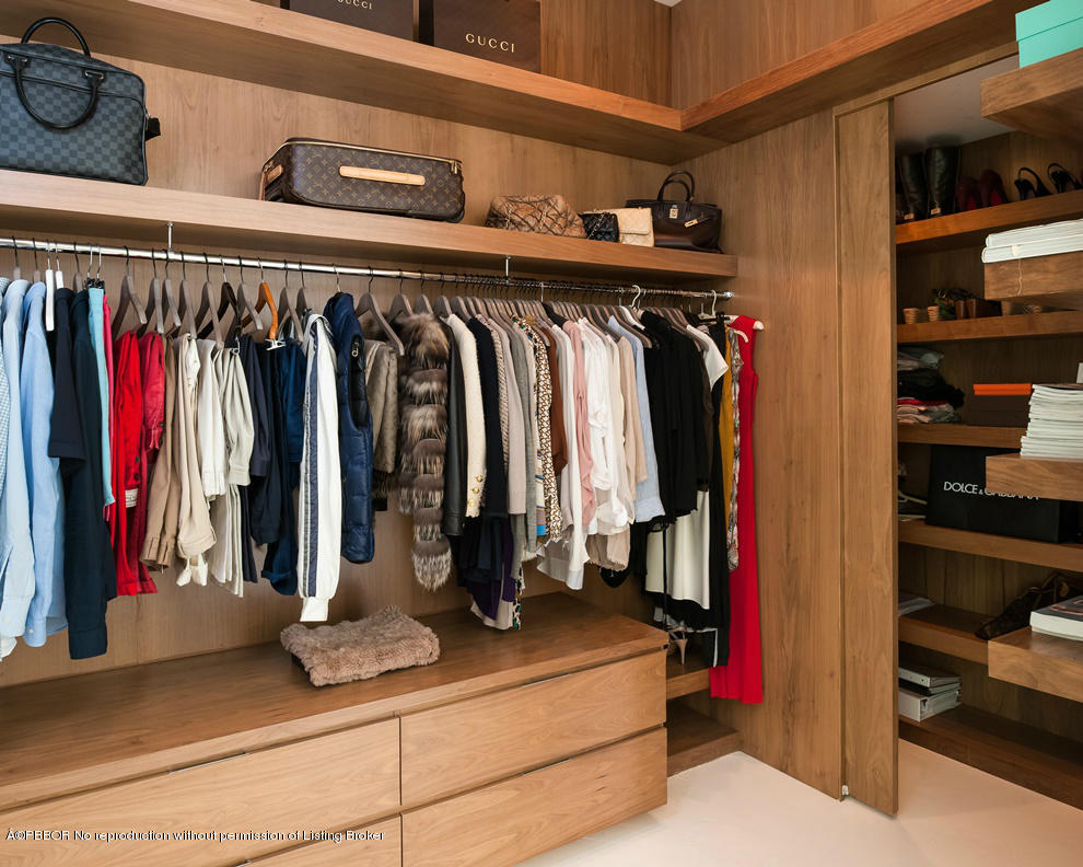 1225 Lands End Road Manalapan, FL 33462 - Photo 14 of 28 a view of walk in closet with clothes and shoes