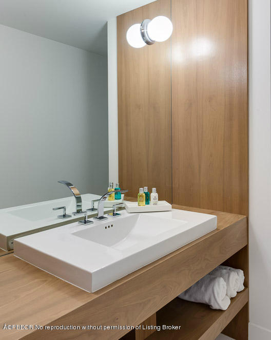 1225 Lands End Road Manalapan, FL 33462 - Photo 16 of 28 a bathroom with a sink and a mirror