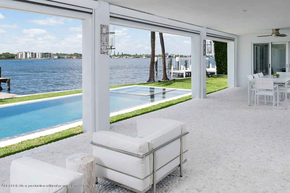 1225 Lands End Road Manalapan, FL 33462 - Photo 22 of 28 a living room with a floor to ceiling window and pool