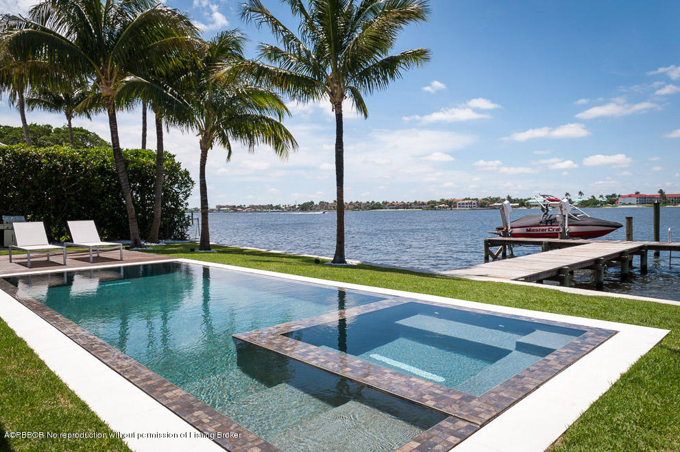1225 Lands End Road Manalapan, FL 33462 - Photo 24 of 28 a view of a swimming pool with a chair