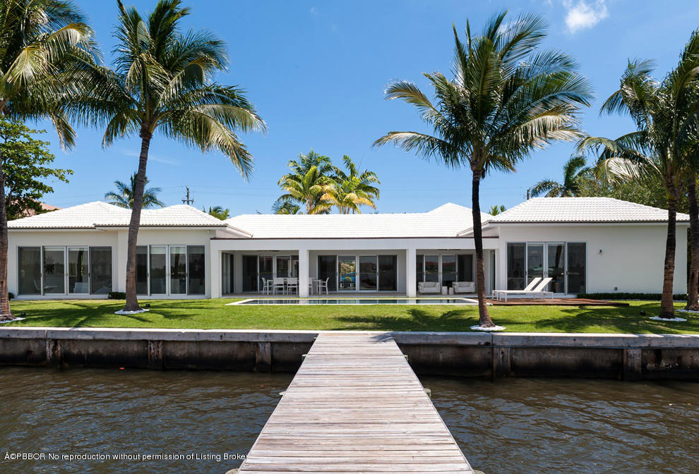 1225 Lands End Road Manalapan, FL 33462 - Photo 25 of 28 a front view of a house with a yard and potted plants