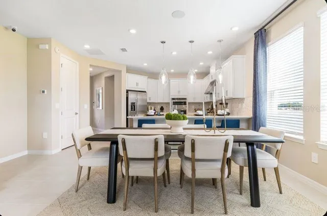 a large white kitchen with a large window