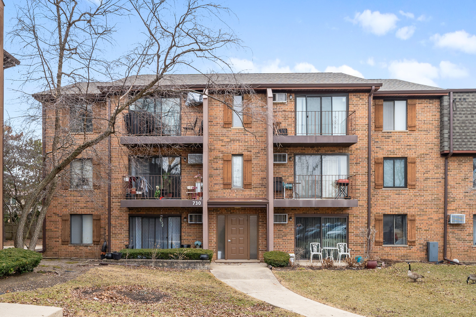 730 Briar Hill Lane, Unit 1 Addison, IL 60101 - Photo 2 of 16 a front view of a residential apartment building with a yard