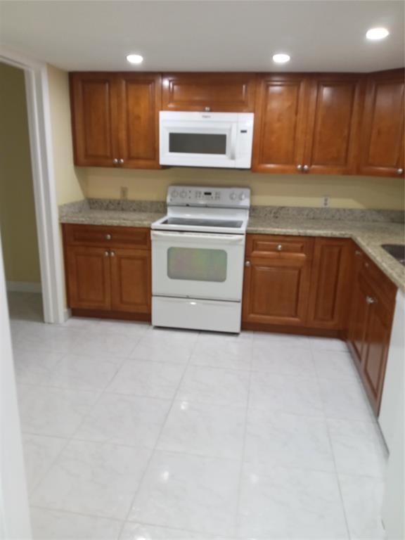 Undisclosed Address Fort Lauderdale, FL 33319 - Photo 2 of 2 a kitchen with a stove top oven sink and cabinets