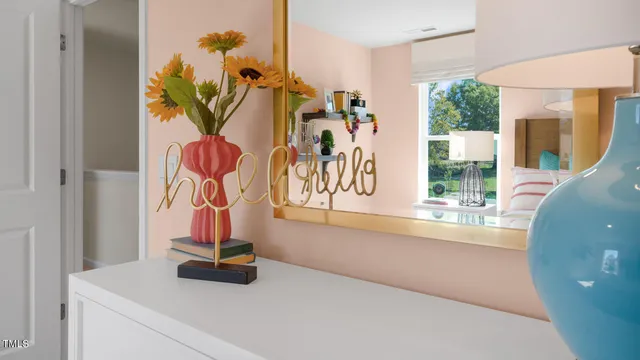 a en suite bathroom with a double vanity sink and a mirror