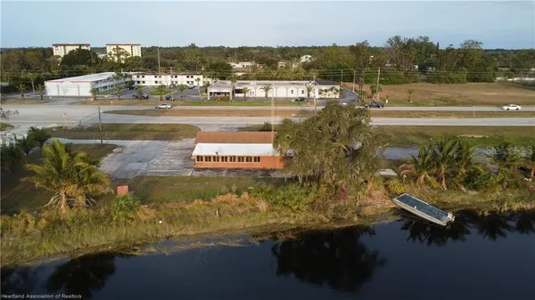 an aerial view of a house with a yard and lake view