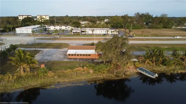 an aerial view of a house with a yard and lake view