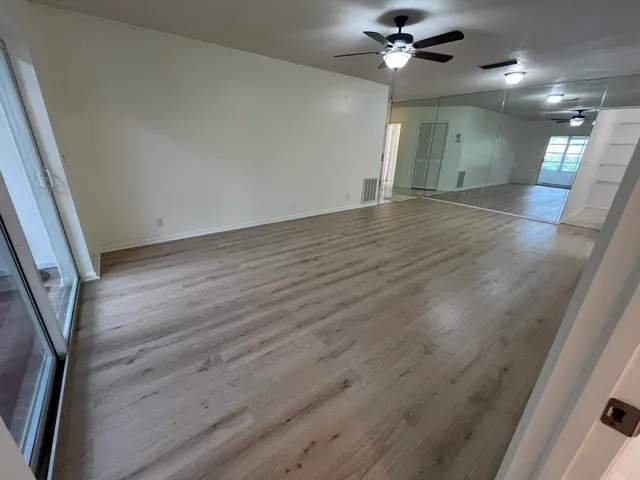 wooden floor in an empty room with a window