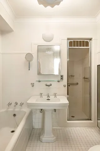 a bathroom with a bathtub a sink and a mirror