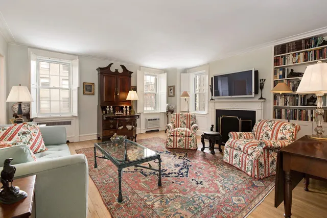 a living room with furniture fireplace and window