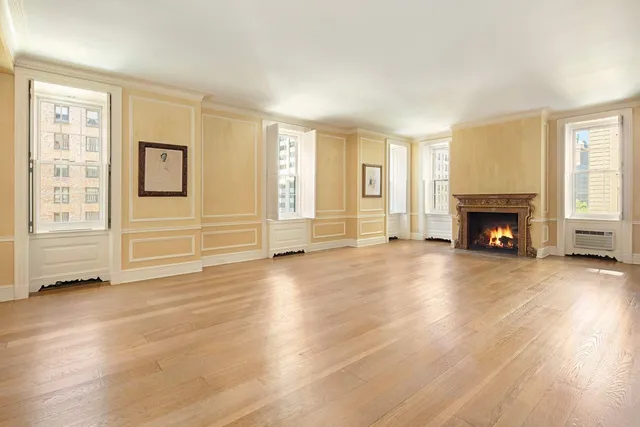 a view of a livingroom with furniture a fireplace and wooden floor