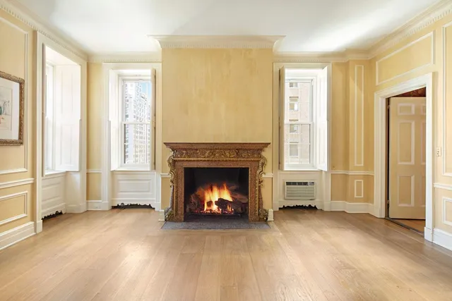 a view of a livingroom with a fireplace and window